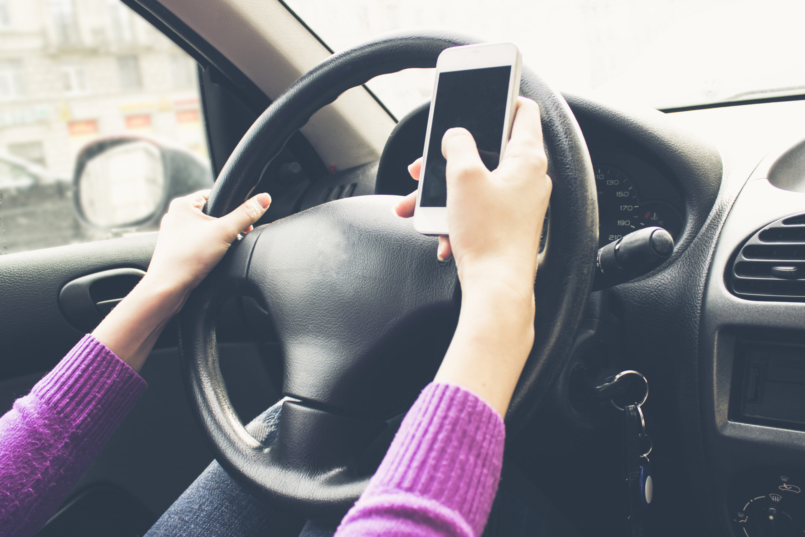 Holding Cell Phone While Driving is Still Distracted Driving - Warnett Hallen LLP