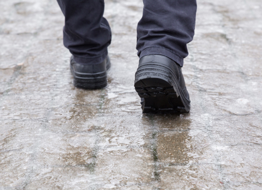 Person walking on icy sidewalk, illustrating slip and fall accident risk for Vancouver occupiers’ liability claims.