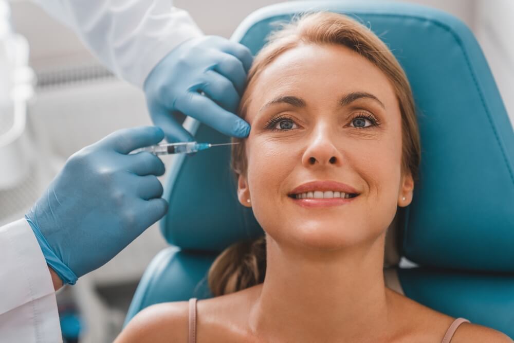 Woman receiving Botox injection from licensed provider, highlighting risks of cosmetic procedure injuries in British Columbia.