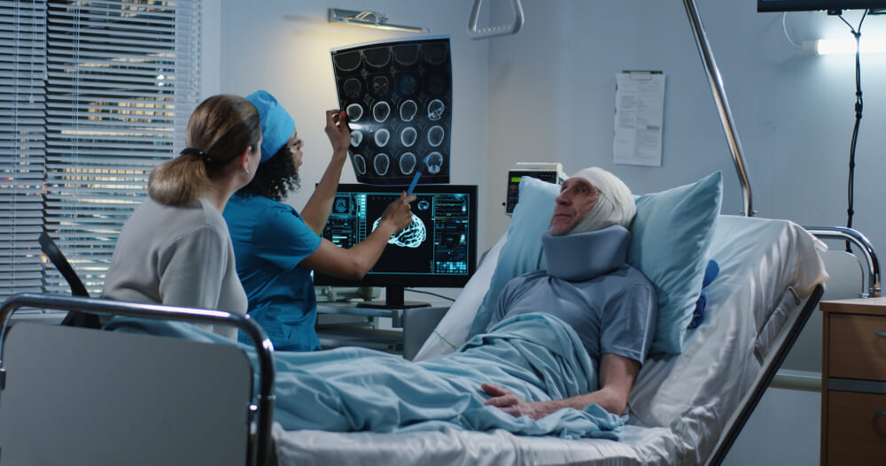 Doctor reviewing brain scans with injured patient after concussion in BC hospital