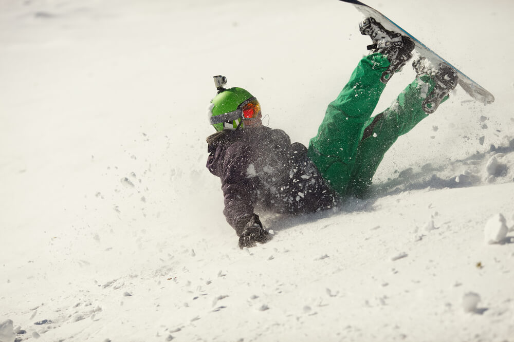 Snowboarder falling on a Vancouver ski slope after an accident — representing winter sports injuries in British Columbia.