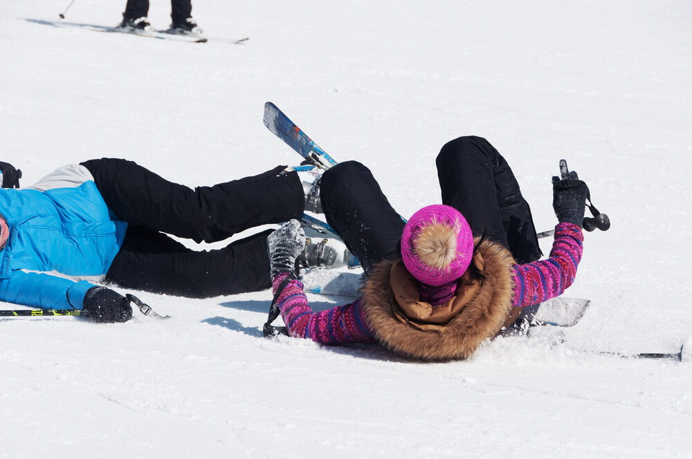 Two skiers collide on a snowy slope in BC, illustrating ski accident injuries handled by Vancouver ski and snowboard lawyers.