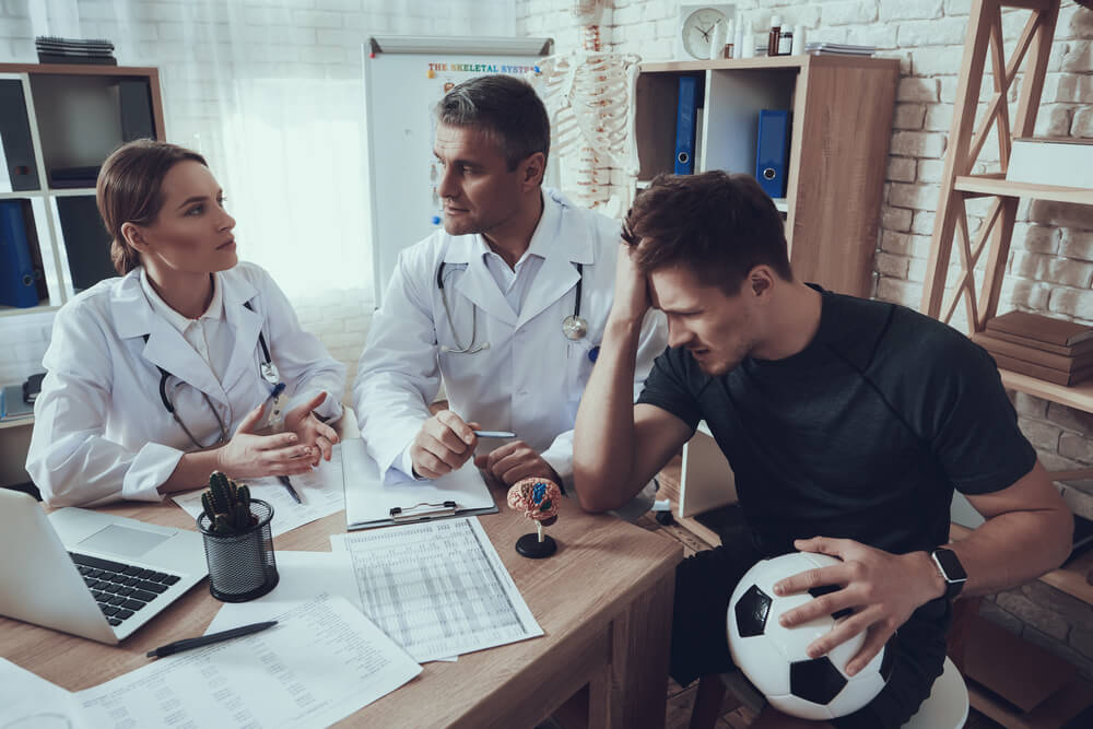 Soccer player consulting doctors for concussion symptoms after head injury in British Columbia.