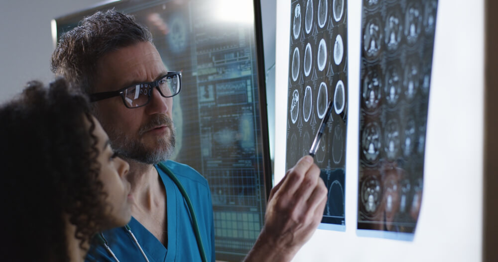 Doctor reviewing brain scan with patient for brain injury insurance claim in BC