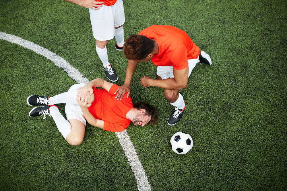 Soccer player injured on field during a game, highlighting a soccer injury claim in BC