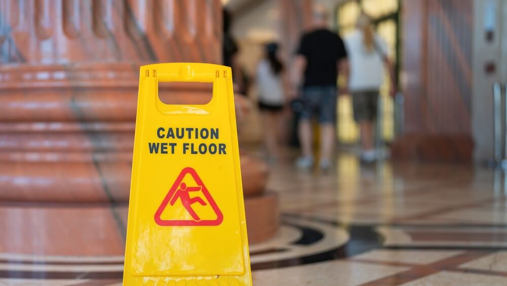 Wet floor warning sign for a slip and fall accident at a BC stadium or event venue